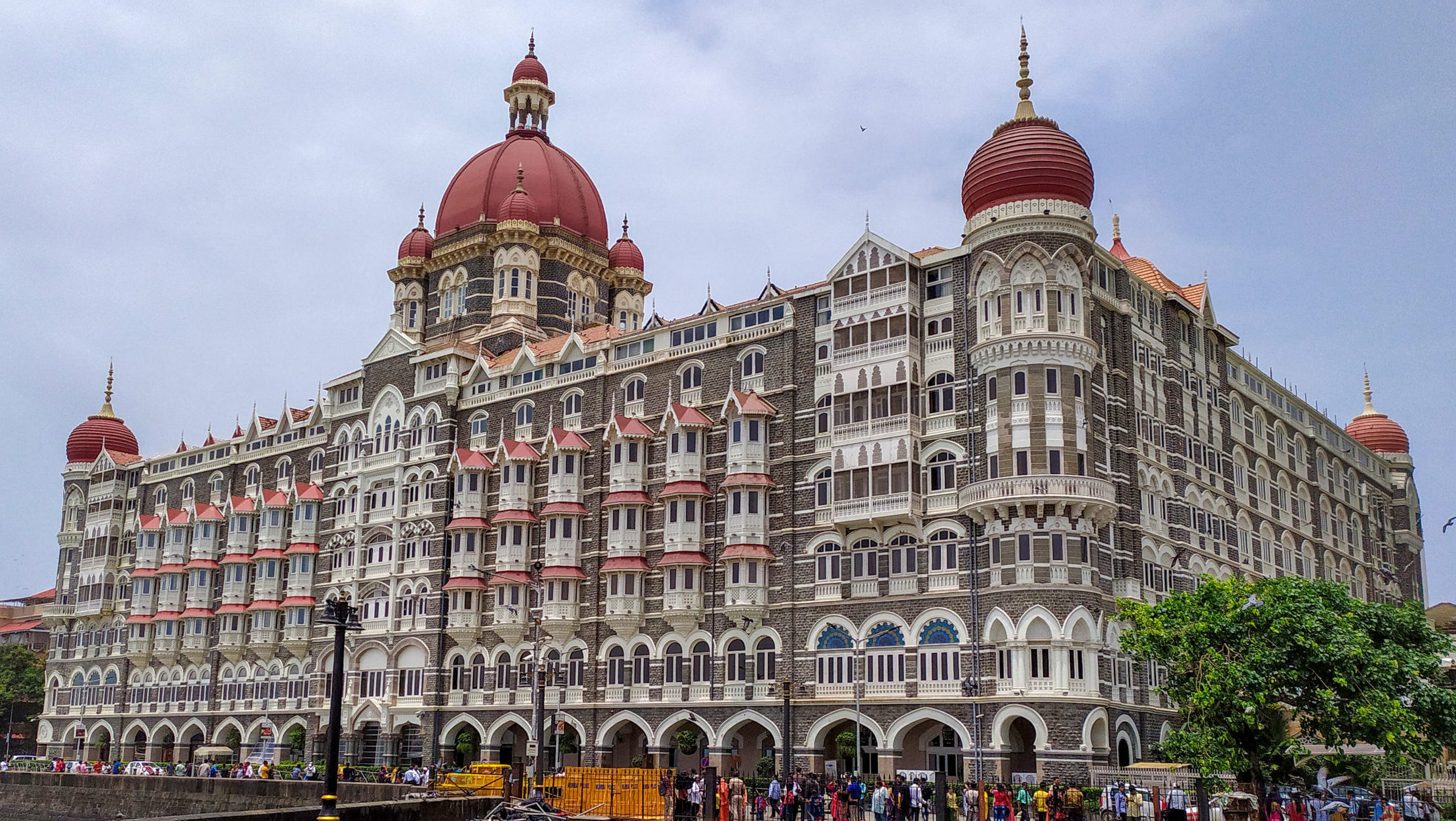 the taj mahal palace hotel in mumbai, india along with visitor and pigeon